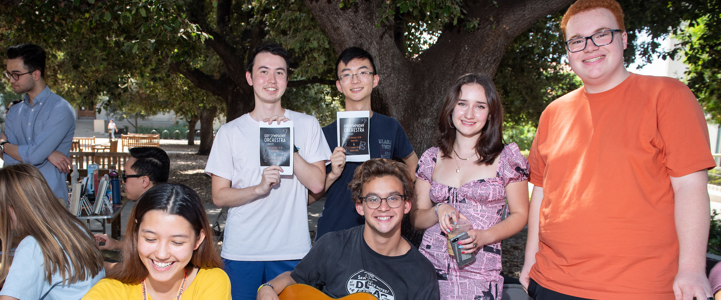 Oxy Music students stand smiling at a fundraiser