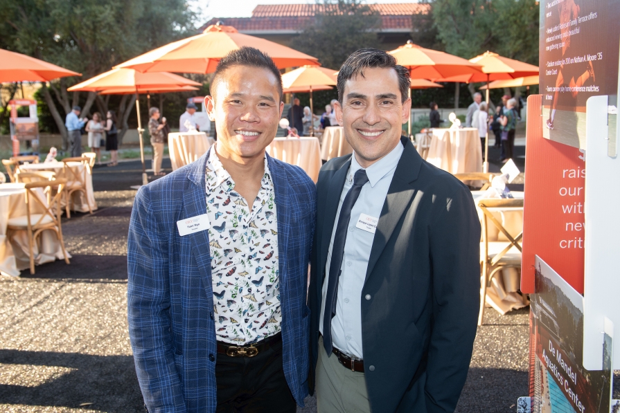 Trustees Tuan Ngo '07 (left) and Enrique López '89 at the campaign celebration on October 5, 2023.