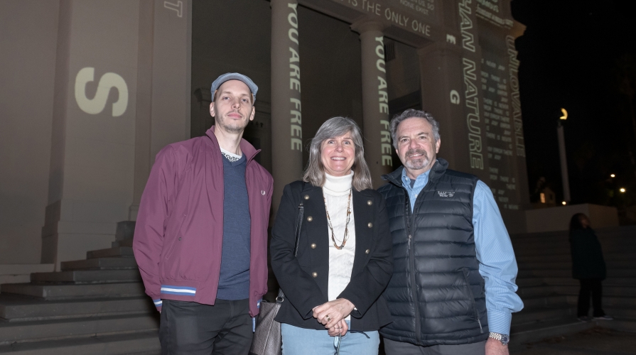 Artist Keith Skretch and Jane and Bob Ettinger, who established the Ettinger Projected Poetry and Art Project, on November 30, 2018, in the courtyard between Fowler and Johnson halls.