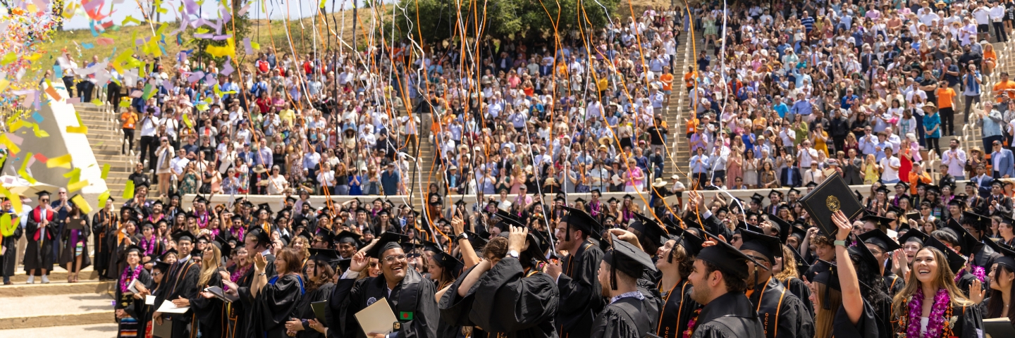 Image of graduates celebrating in the Greek Bowl
