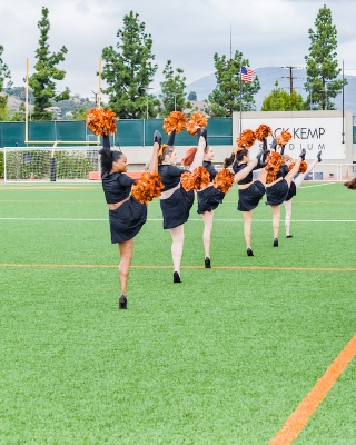 Oxy cheer squad leads a cheer on Patterson Field