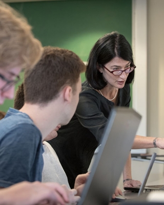 Professor Kathryn Leonard works hands-on with students in a Computer Science class